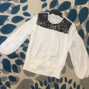 Never worn. White and black top.